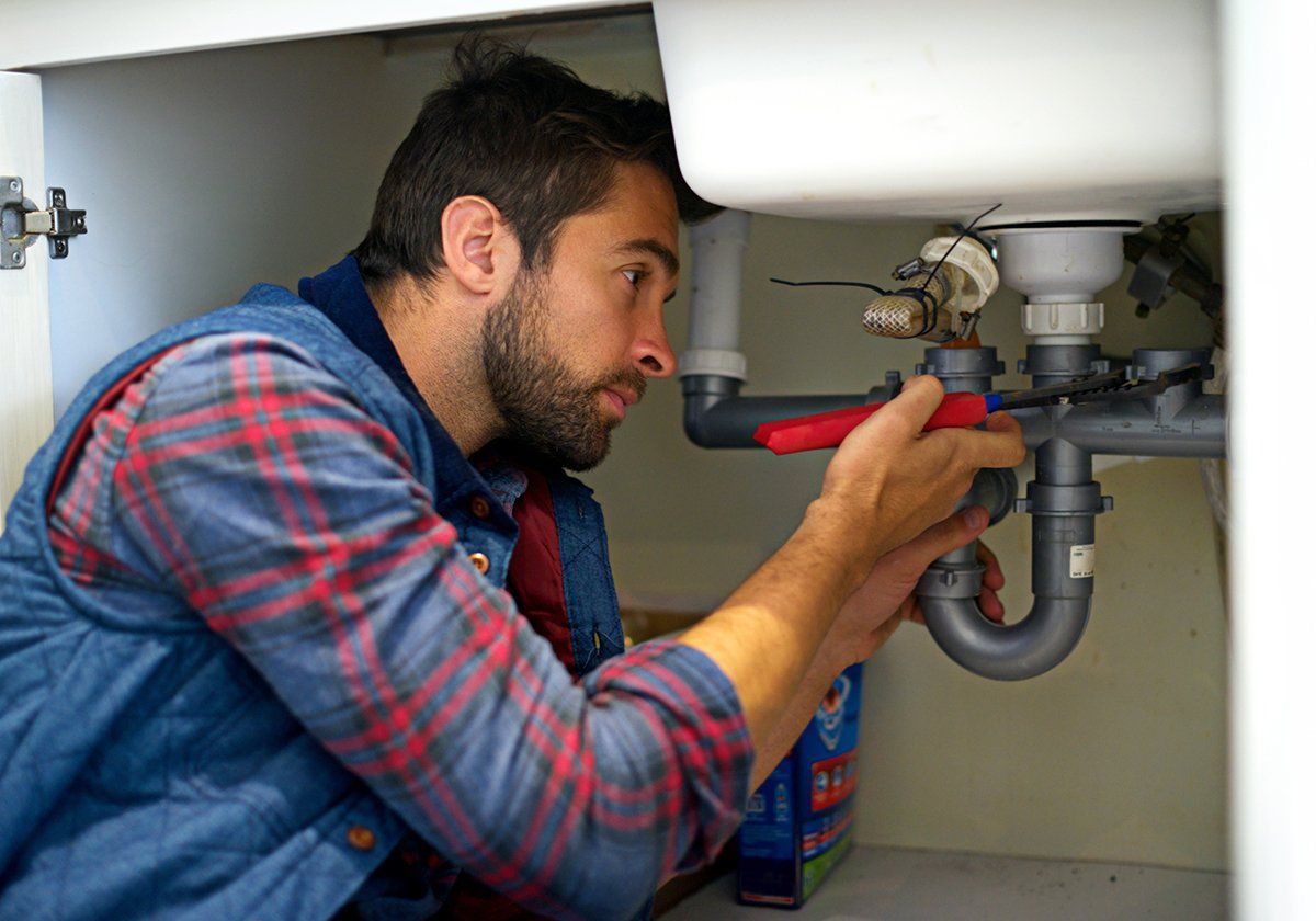 Plumber Fixing The Kitchen Pipes — Santa Ana, CA — A Dan The Handyman
