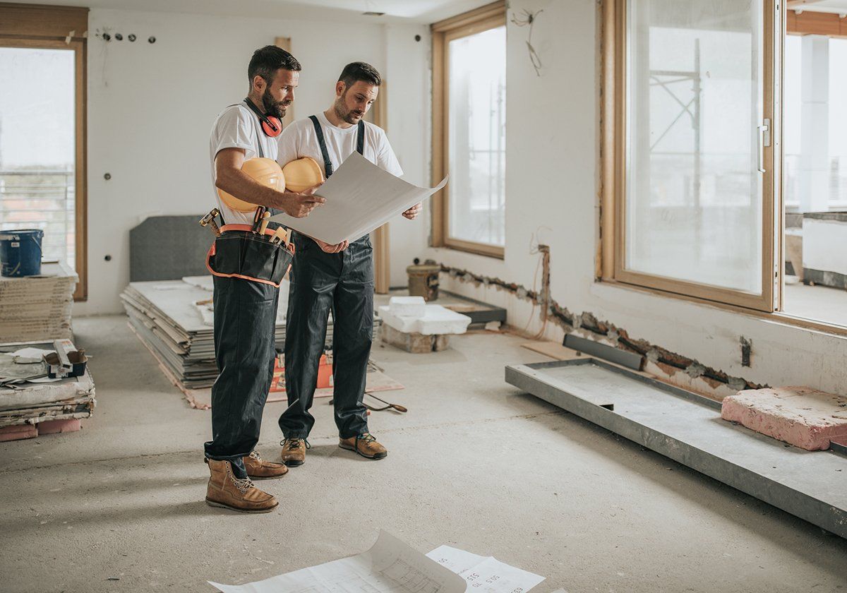 Workers Holding The Renovation Plan — Santa Ana, CA — A Dan The Handyman