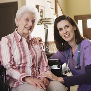 Senior Woman Sitting in Wheel Chair Beside the Nurse — Cleveland, OH — Park Creek Center