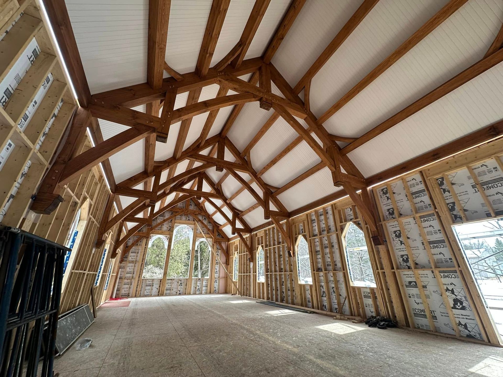 A large room with a wooden ceiling and a lot of windows