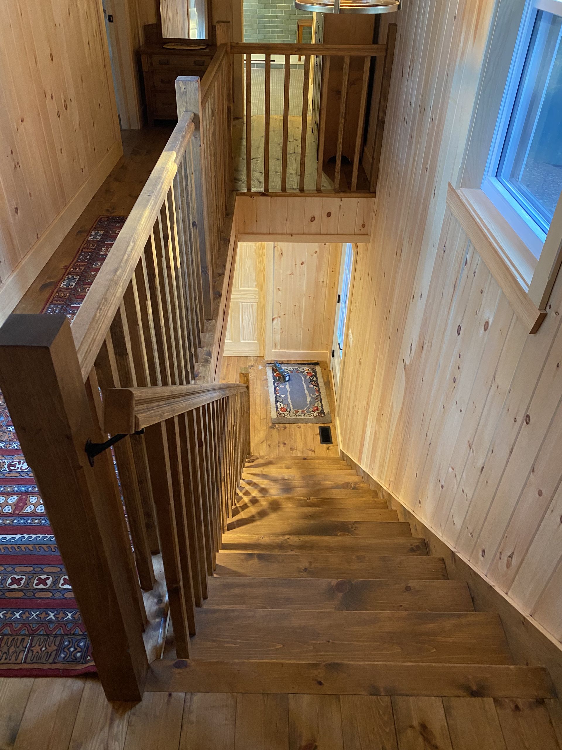 A wooden staircase leading up to the second floor of a house.