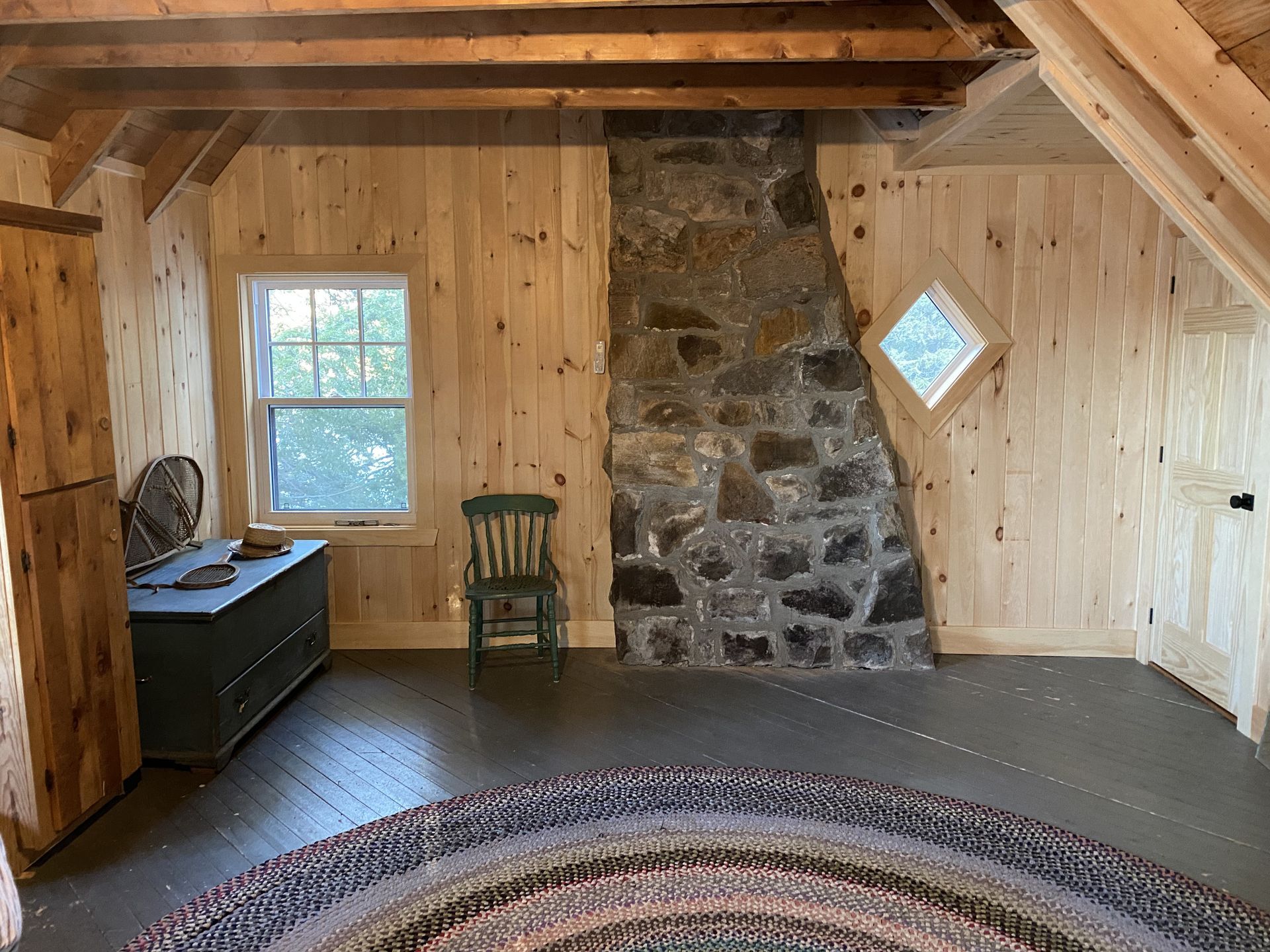 A room with a fireplace and a rug in it
