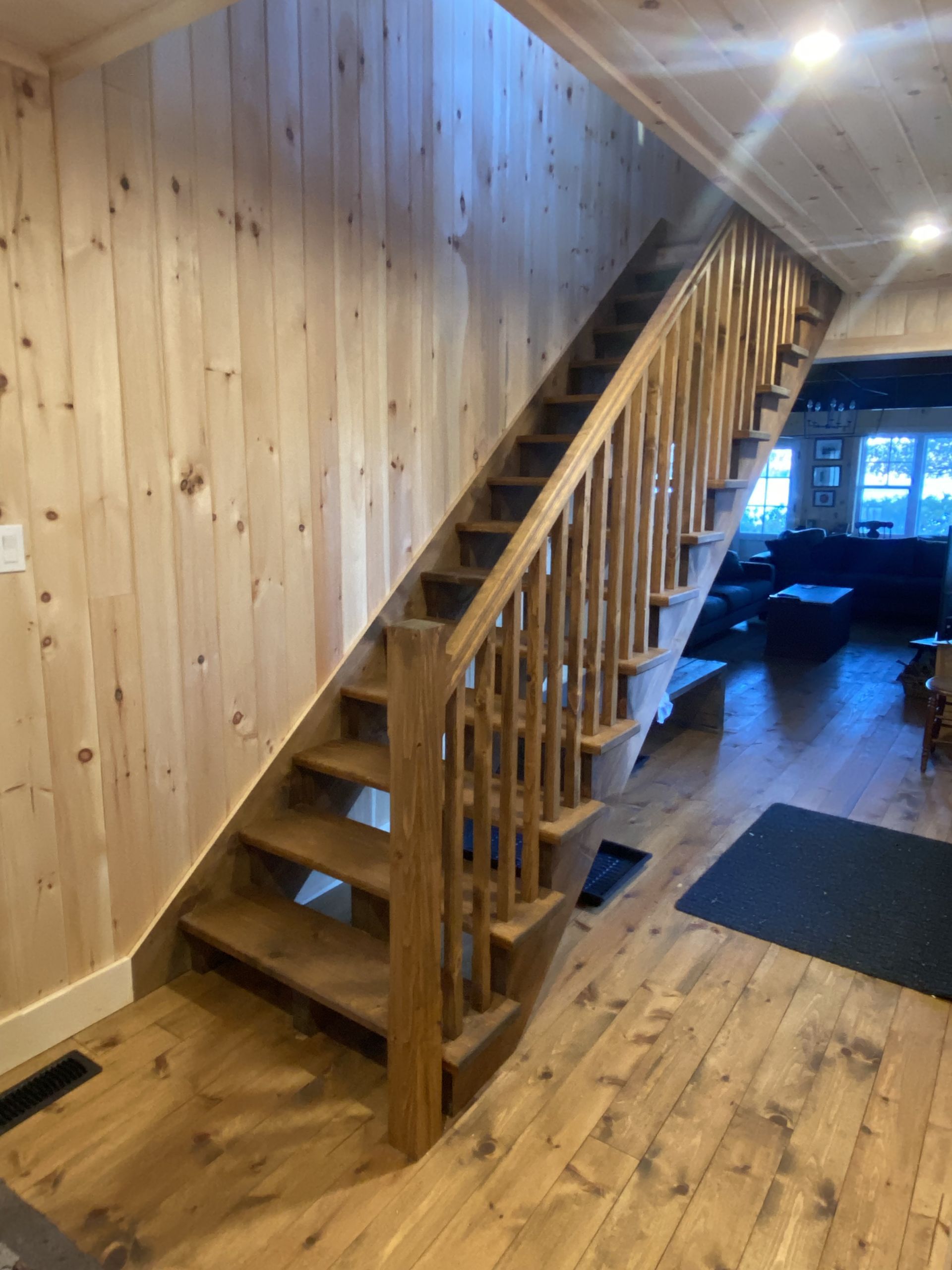 A wooden staircase leading up to the second floor of a house.