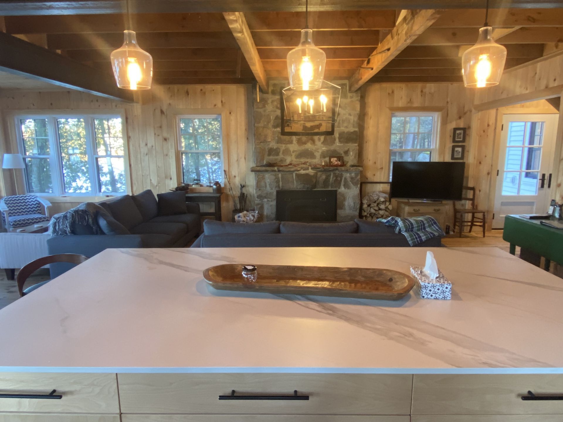 A kitchen island in a living room with a tray on it.