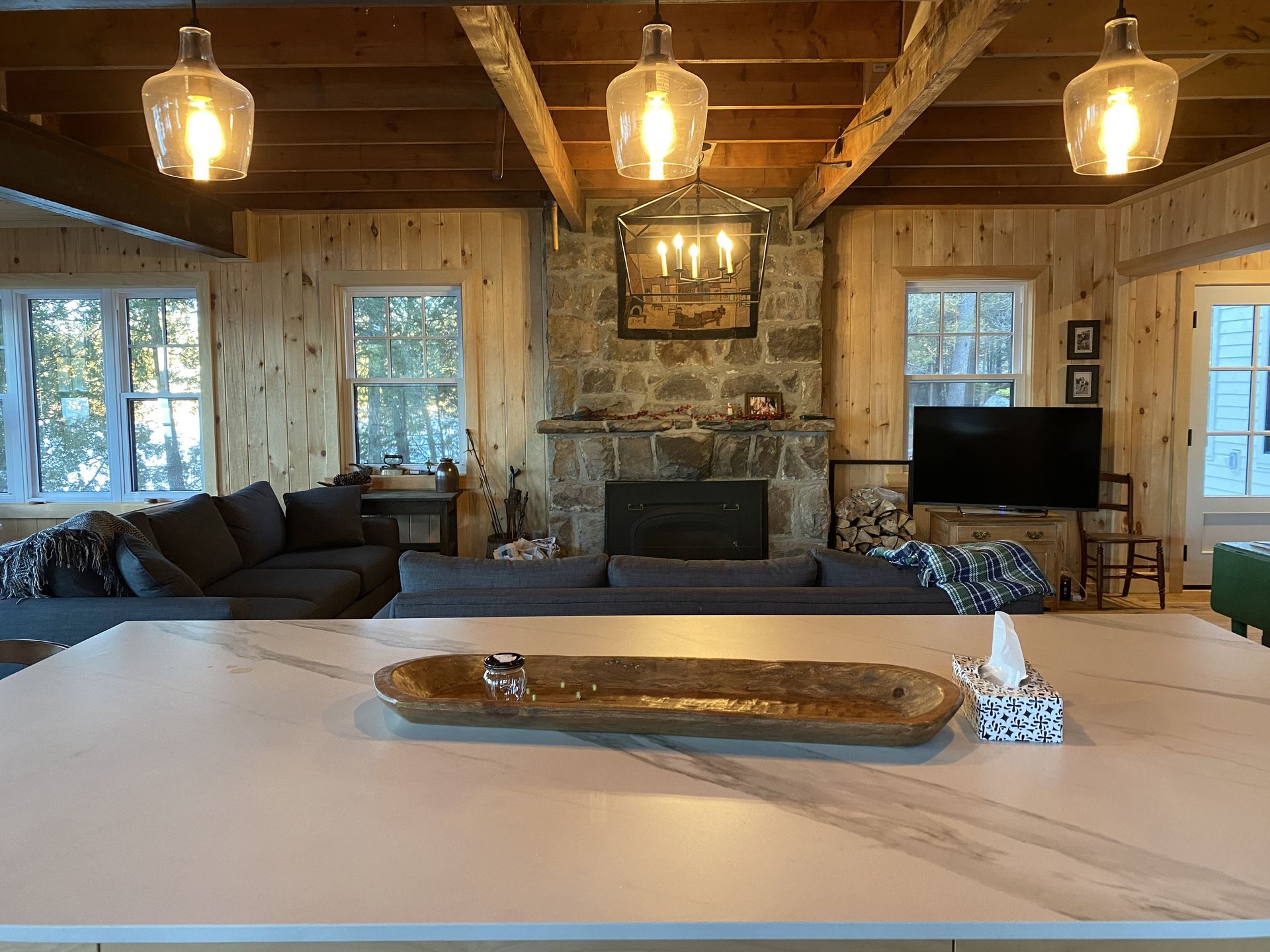 A living room with a fireplace and a flat screen tv