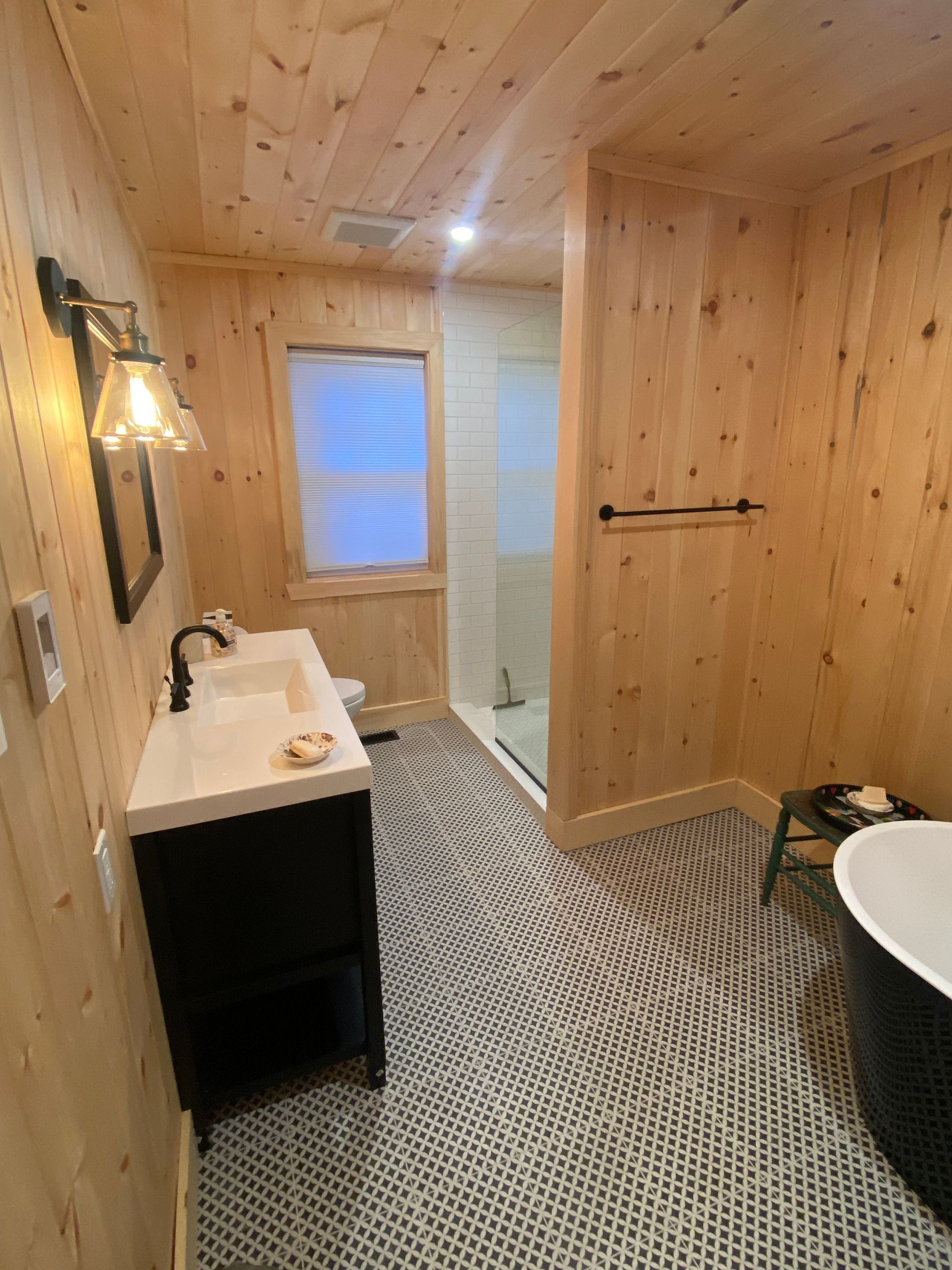 A bathroom with a sink , toilet , shower and bathtub.