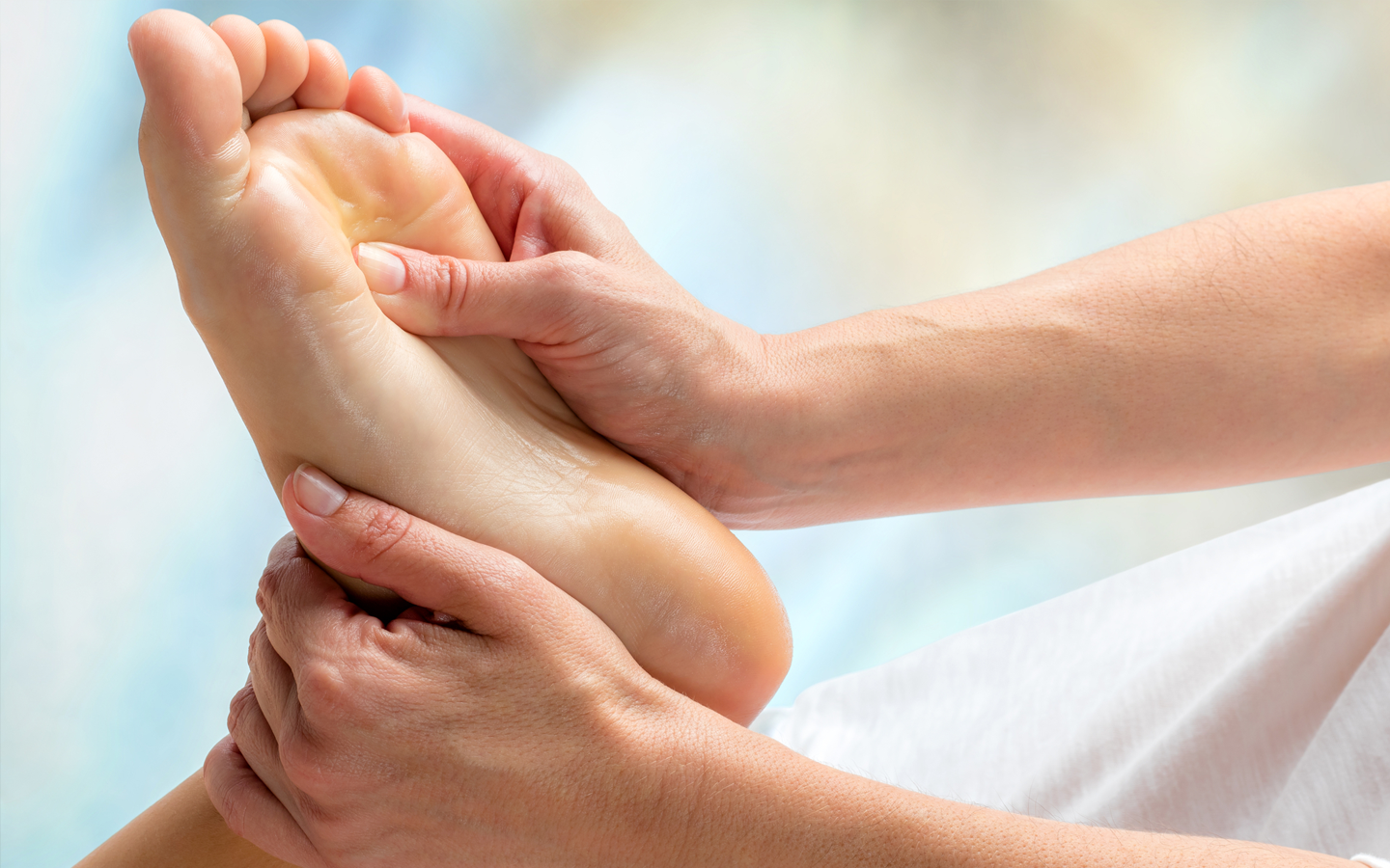 A person is receiving reflexology at Naval Mair Physical Medicine in Wandsworth