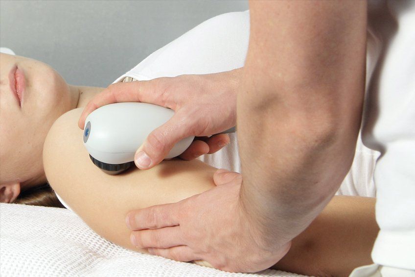 A lady receiving shockwave therapy