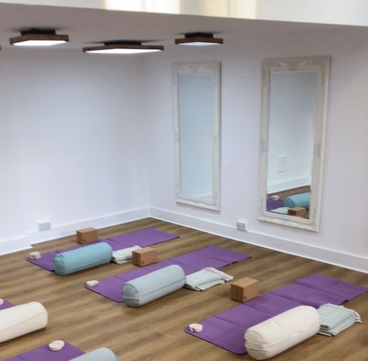 A row of yoga mats and pillows in a room at Naval Mair Physical Medicine