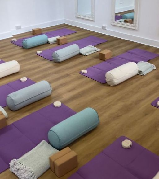 A room filled with purple yoga mats and pillows at Naval Mair Physical Medicine