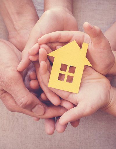 Adult And Child Hands Holding Yellow House — Exton, PA — Longley Insurance Agency Adult And Child Hands Holding Yellow House — Exton, PA — Longley Insurance Agency