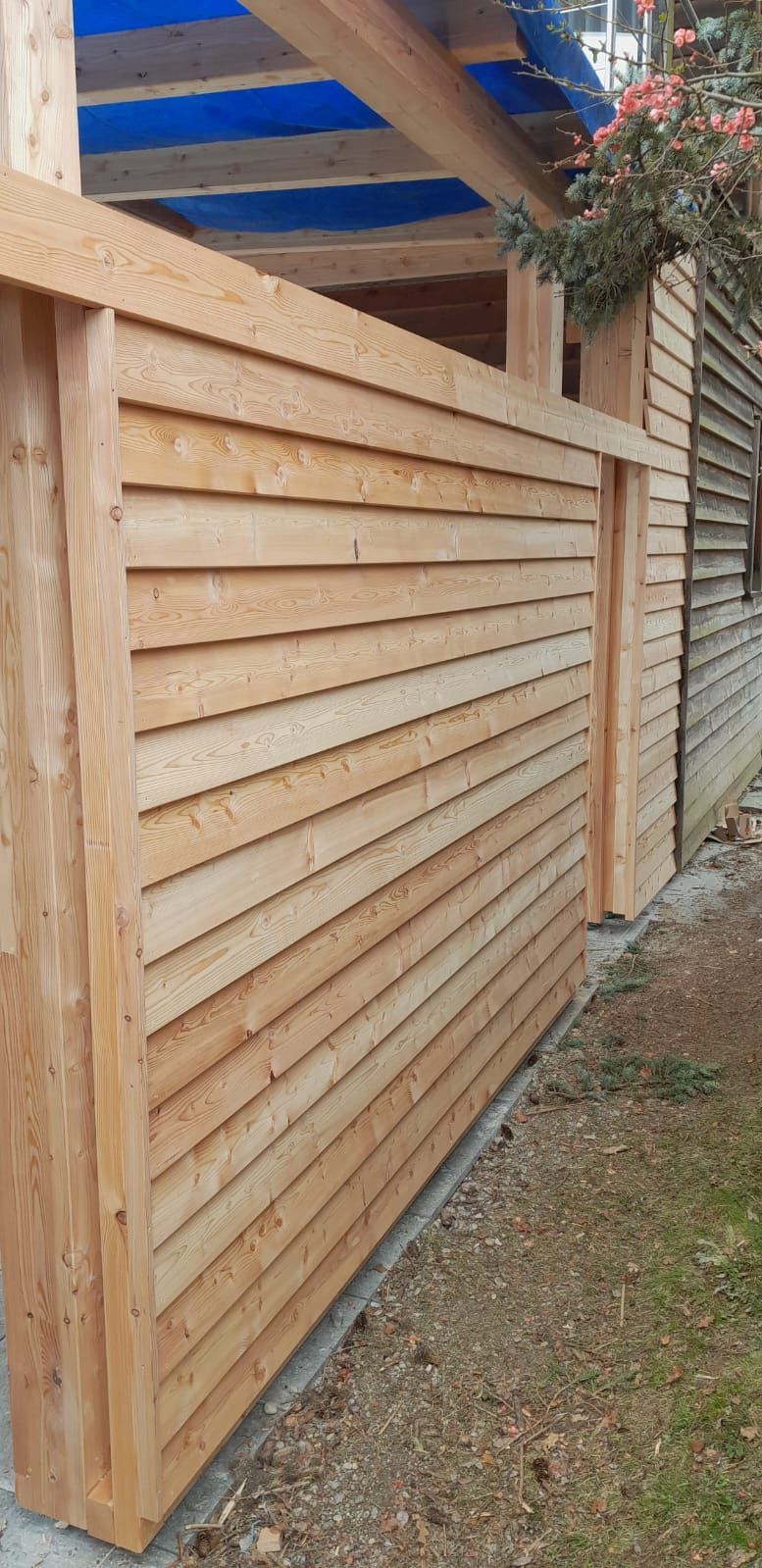 Eine Holzfassade eines Hauses in Nahaufnahme.