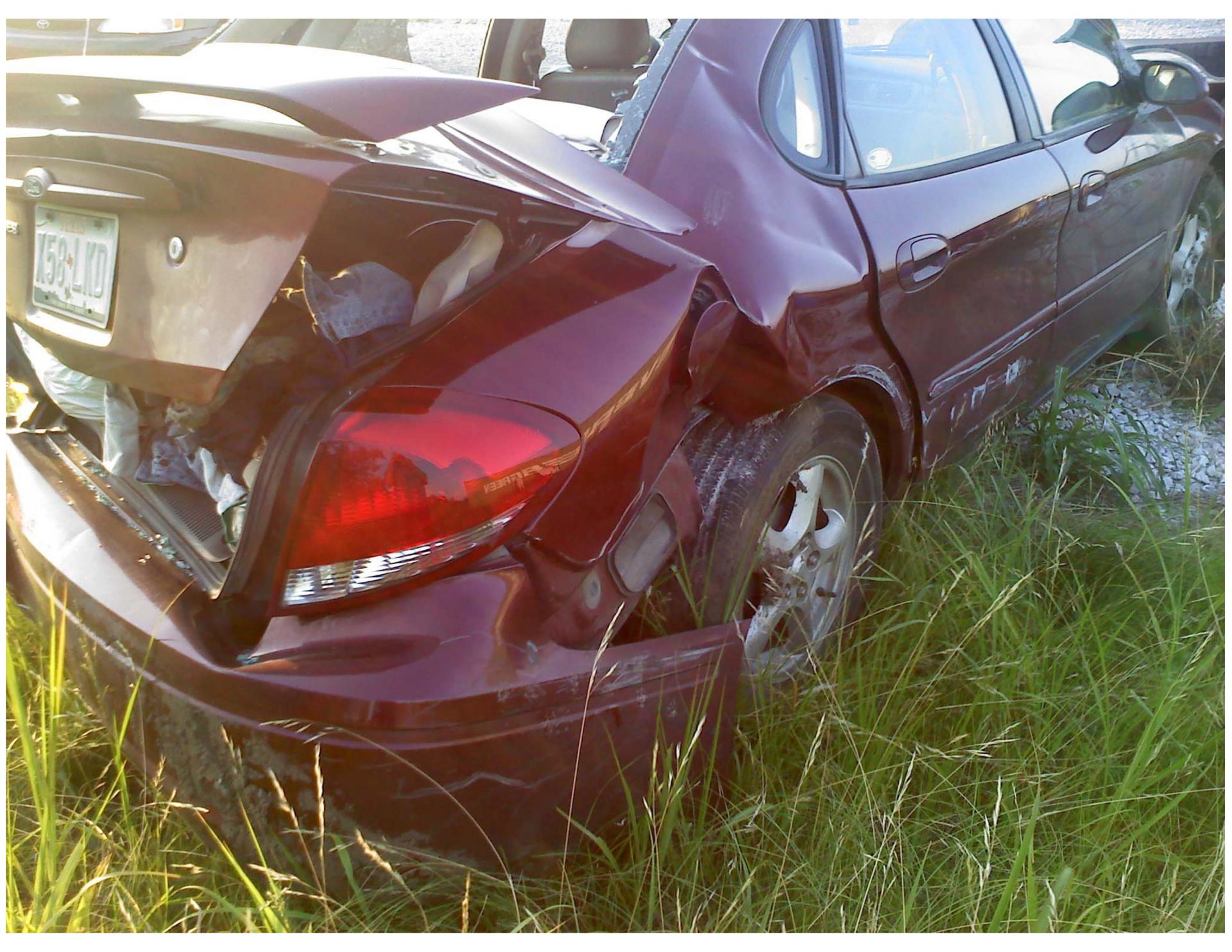A damaged car with a license plate that says fsnj