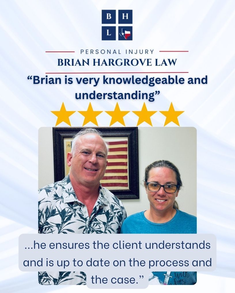 Car accident attorney Brian Hargrove and client stand next to one another, smiling. An American flag is framed behind them.
