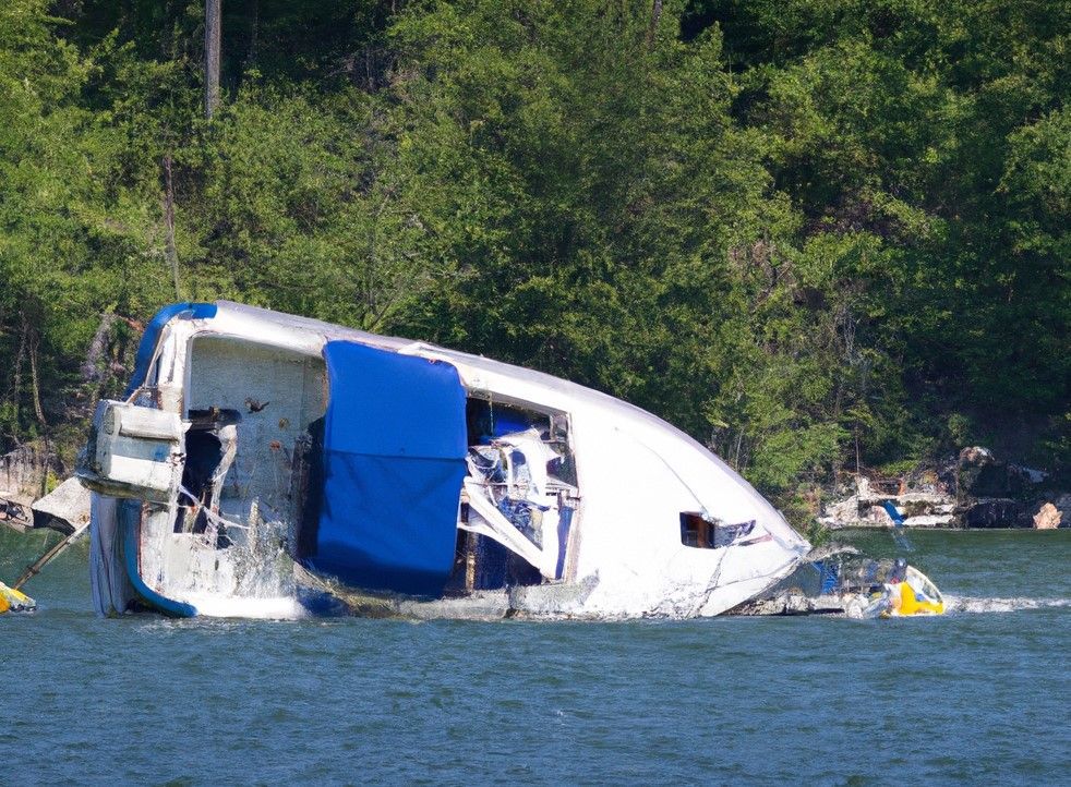A boat is floating on its side in the water