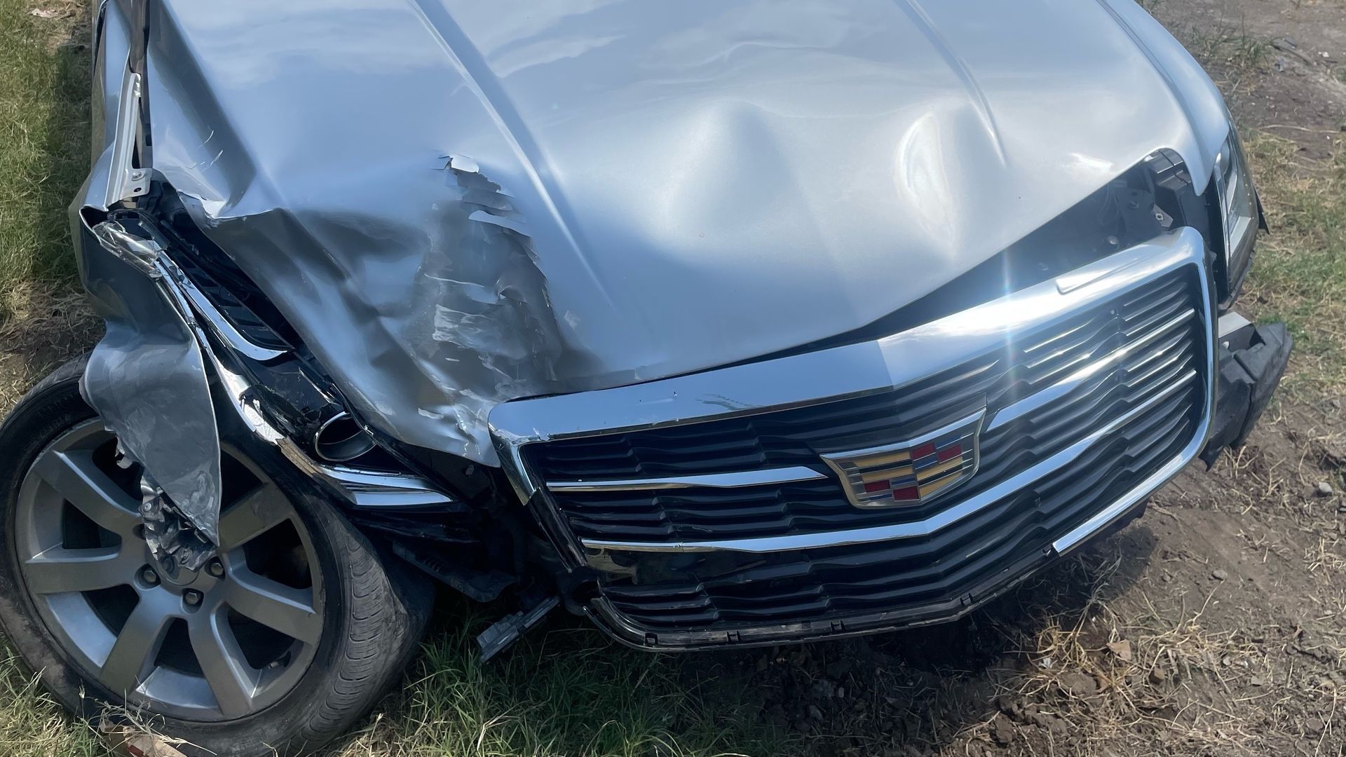 Front passenger side of a silver sedan is smashed after a car crash in Fort Worth.