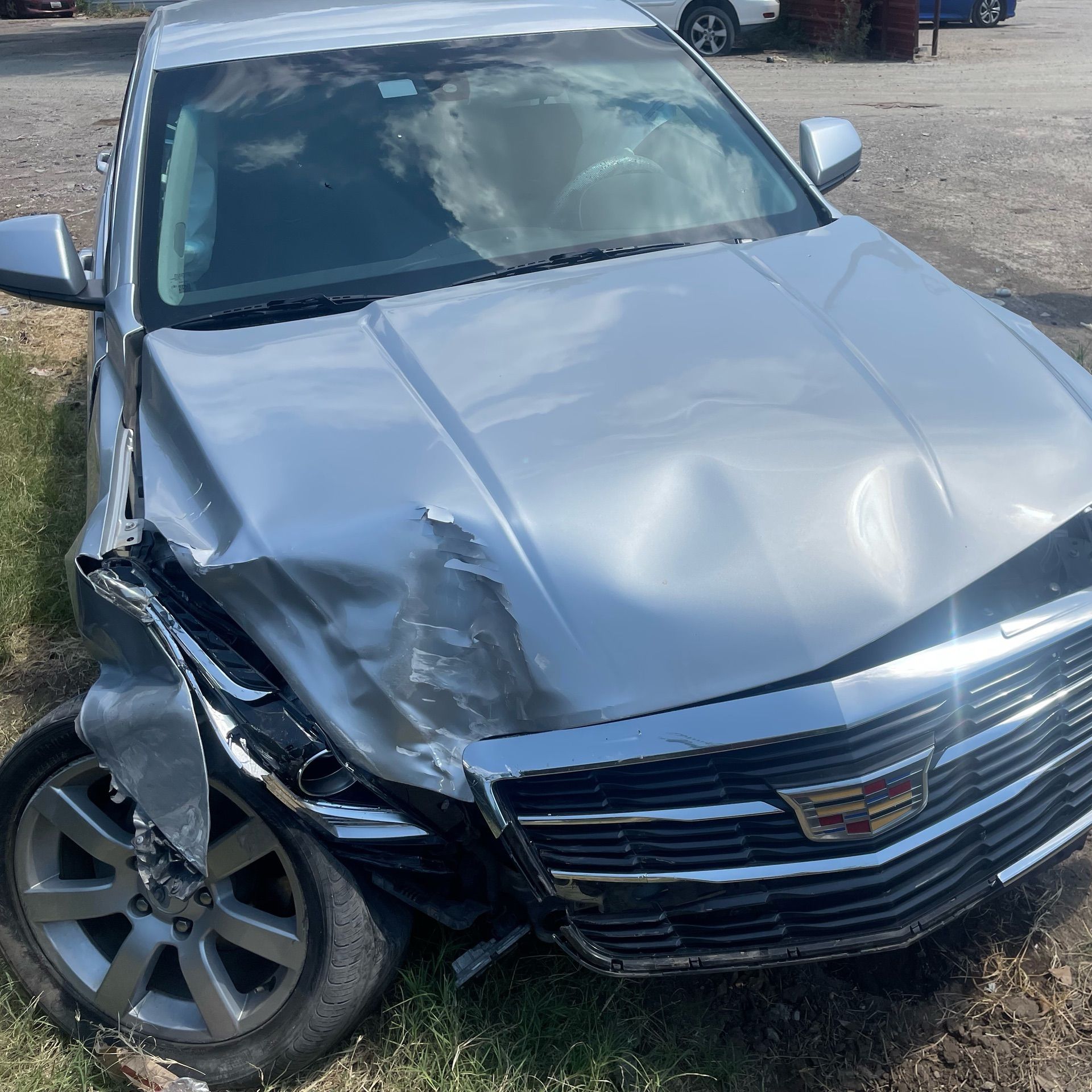 Front passenger side of a silver sedan is smashed after a car crash in Fort Worth.