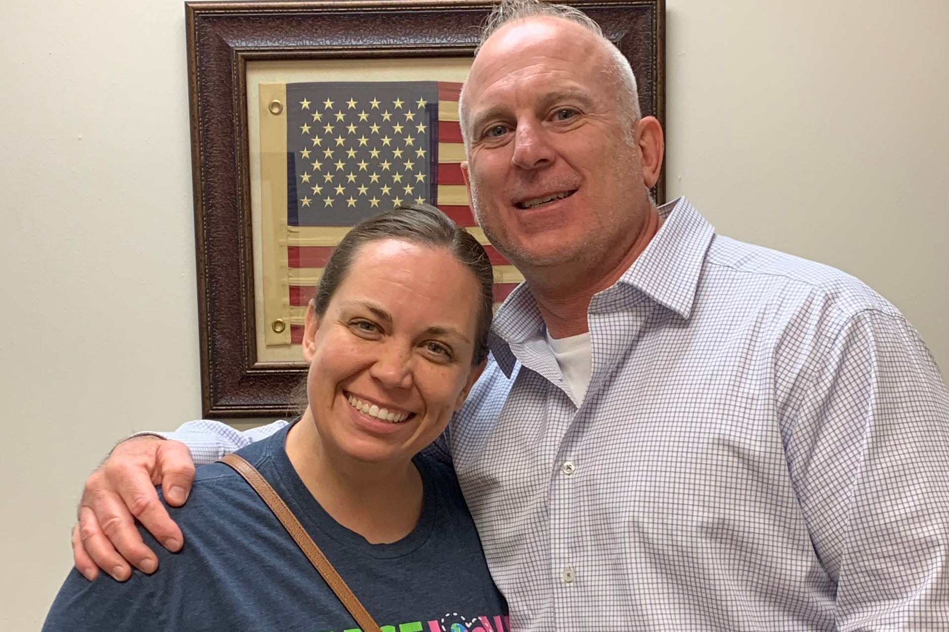 Brian posing with happy client Lisa F. after her settlement.