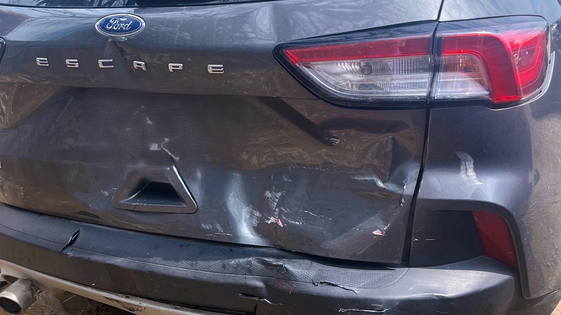 Back-end of a gray Ford sedan is crumpled up from a speeding car accident in Denton.