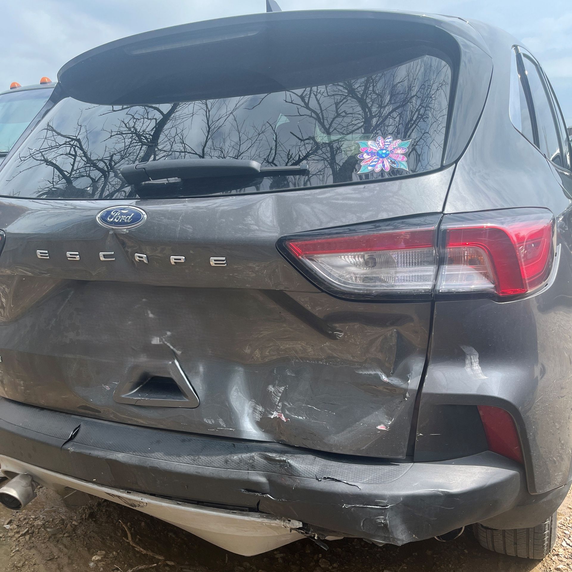 Back-end of a gray Ford sedan is crumpled up from a speeding car accident in Denton.