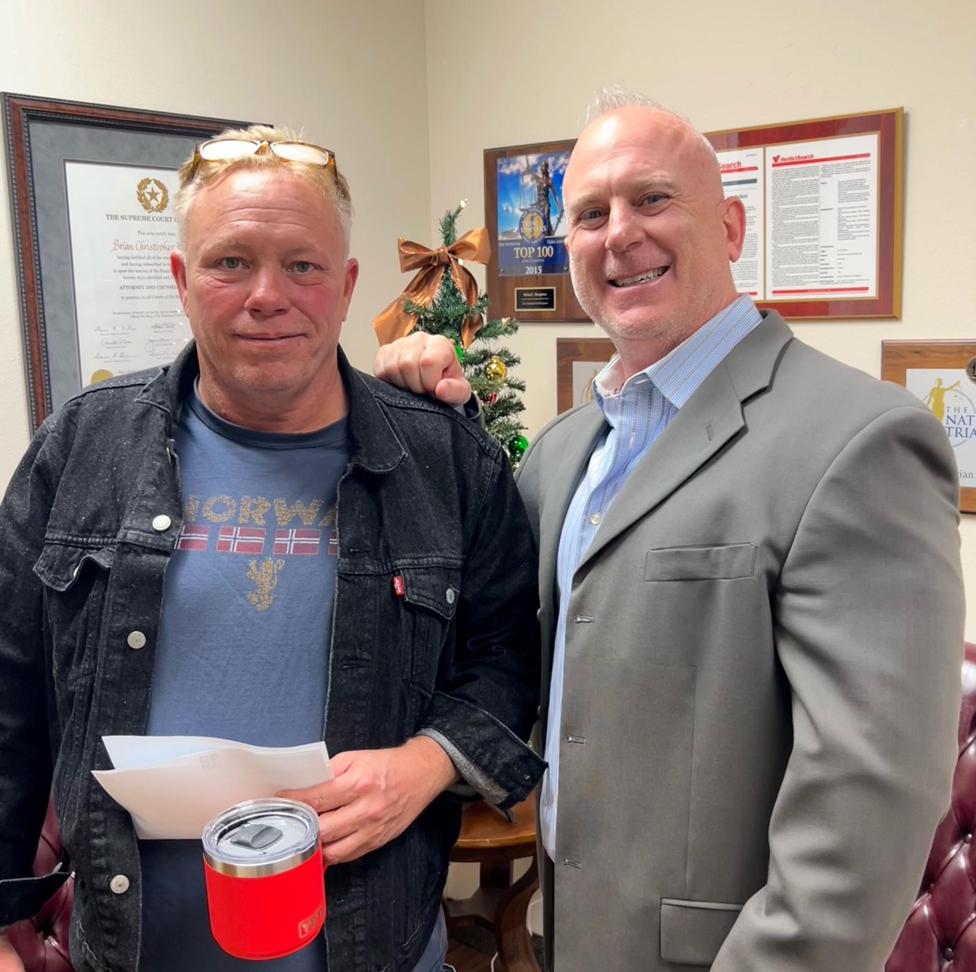 Client, Chris, next to Brian Hargrove after receiving his full compensation settlement check.