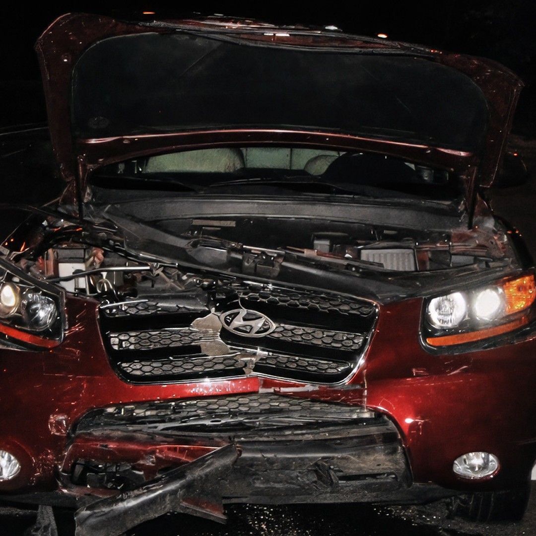 Front end of a red sedan is crushed from a speeding car accident in Dallas.