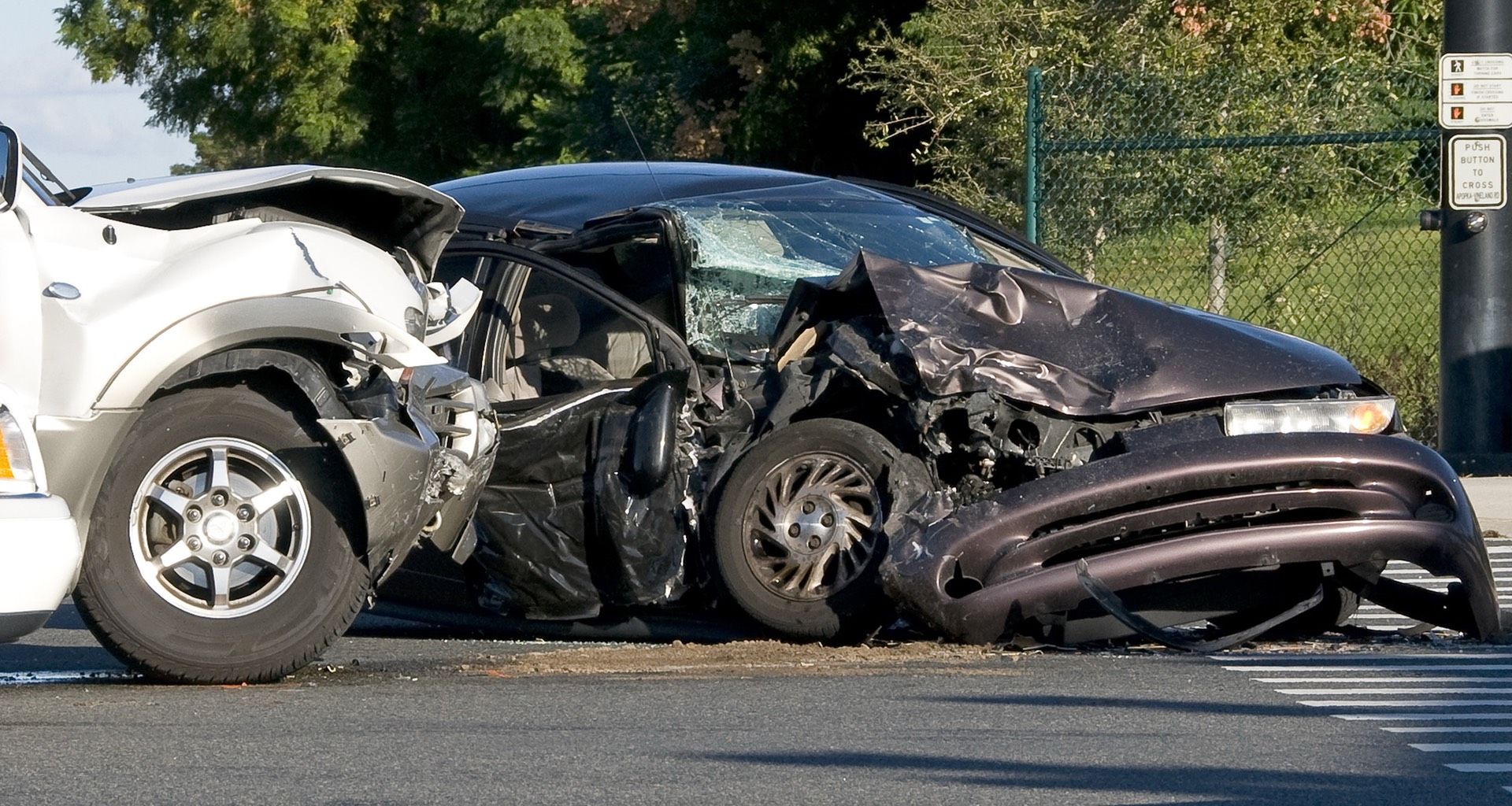 Two smashed vehicles in the middle of an intersection after a negligent driver runs a red light.