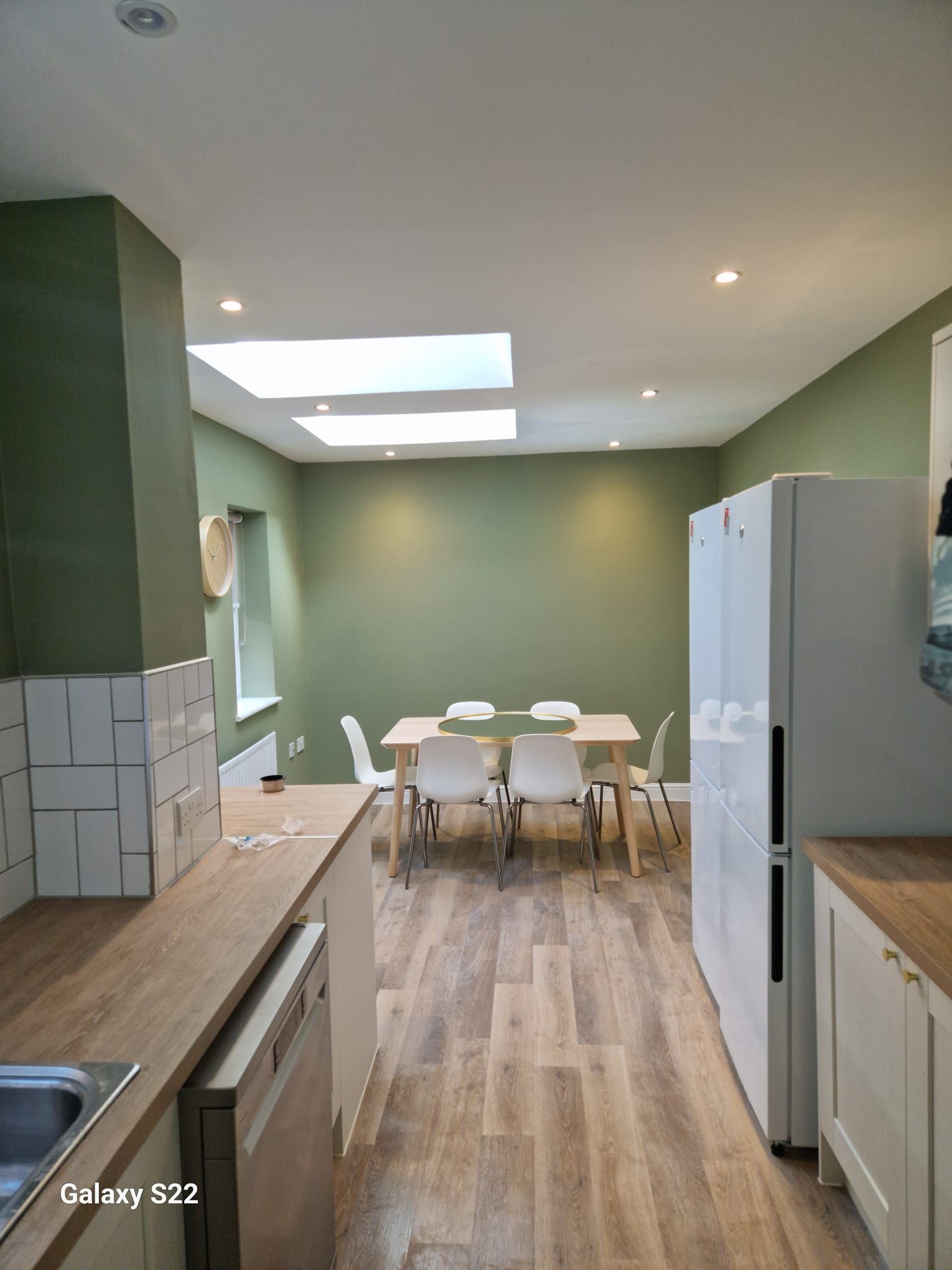 A picture of a kitchen painted light green by Elite Edge Painters and Decorators Manchester