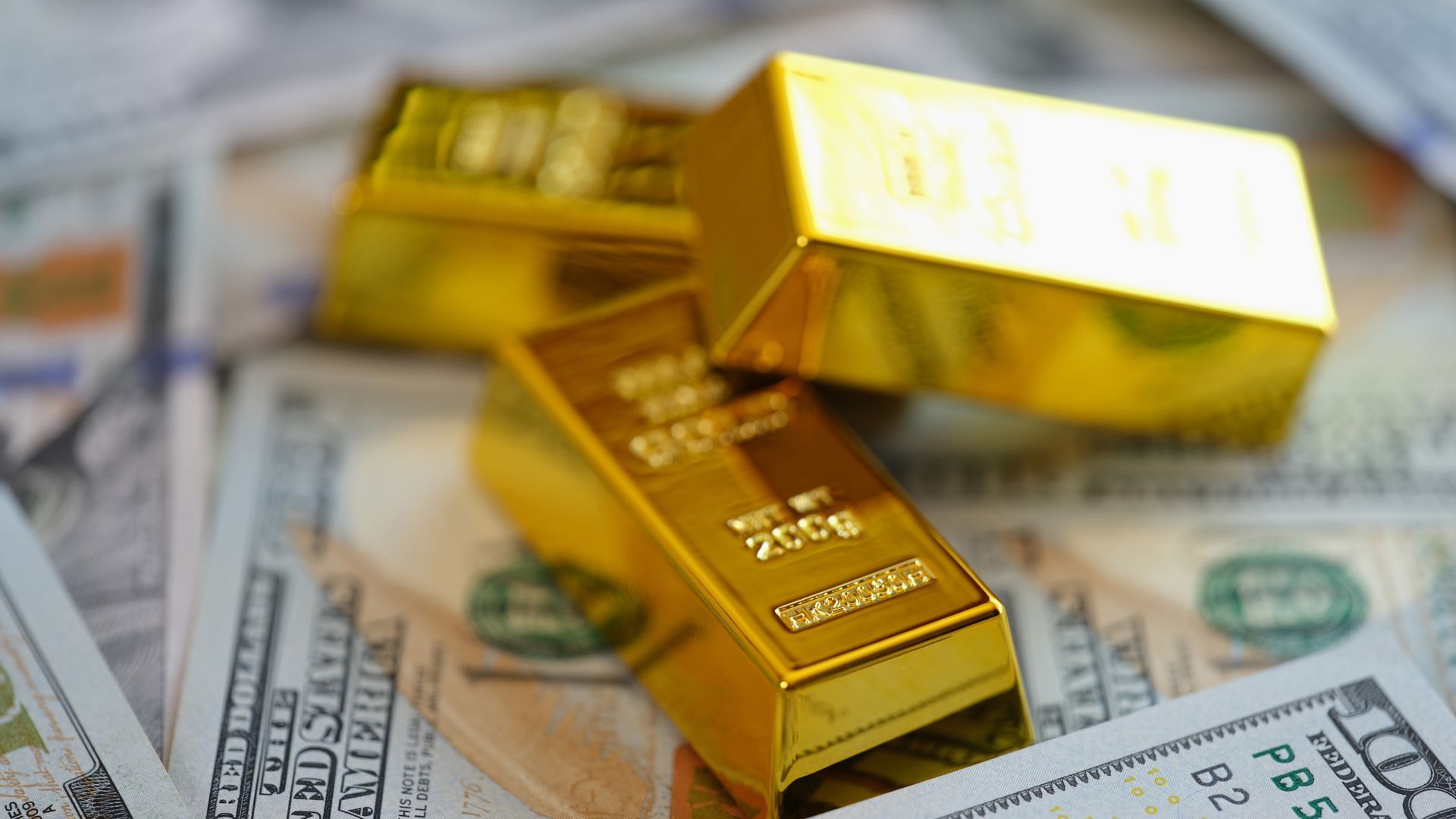 Towering stack of radiant gold bars piled high across scattered US dollar bills.