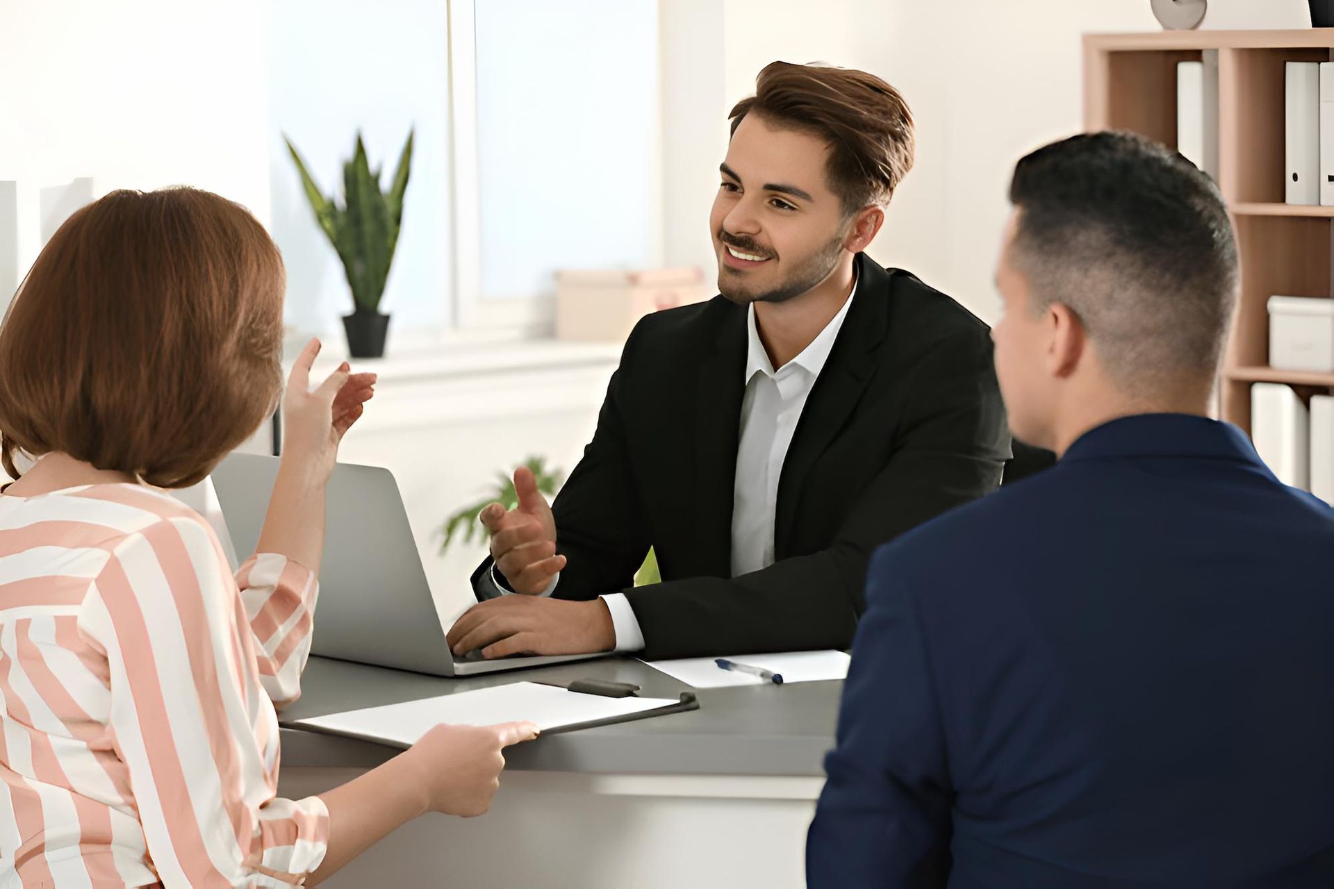 A Man and a Woman Are Sitting at a Table With a Laptop — O'Reilly & Sochacki Lawyers in Murwillumbah, NSW