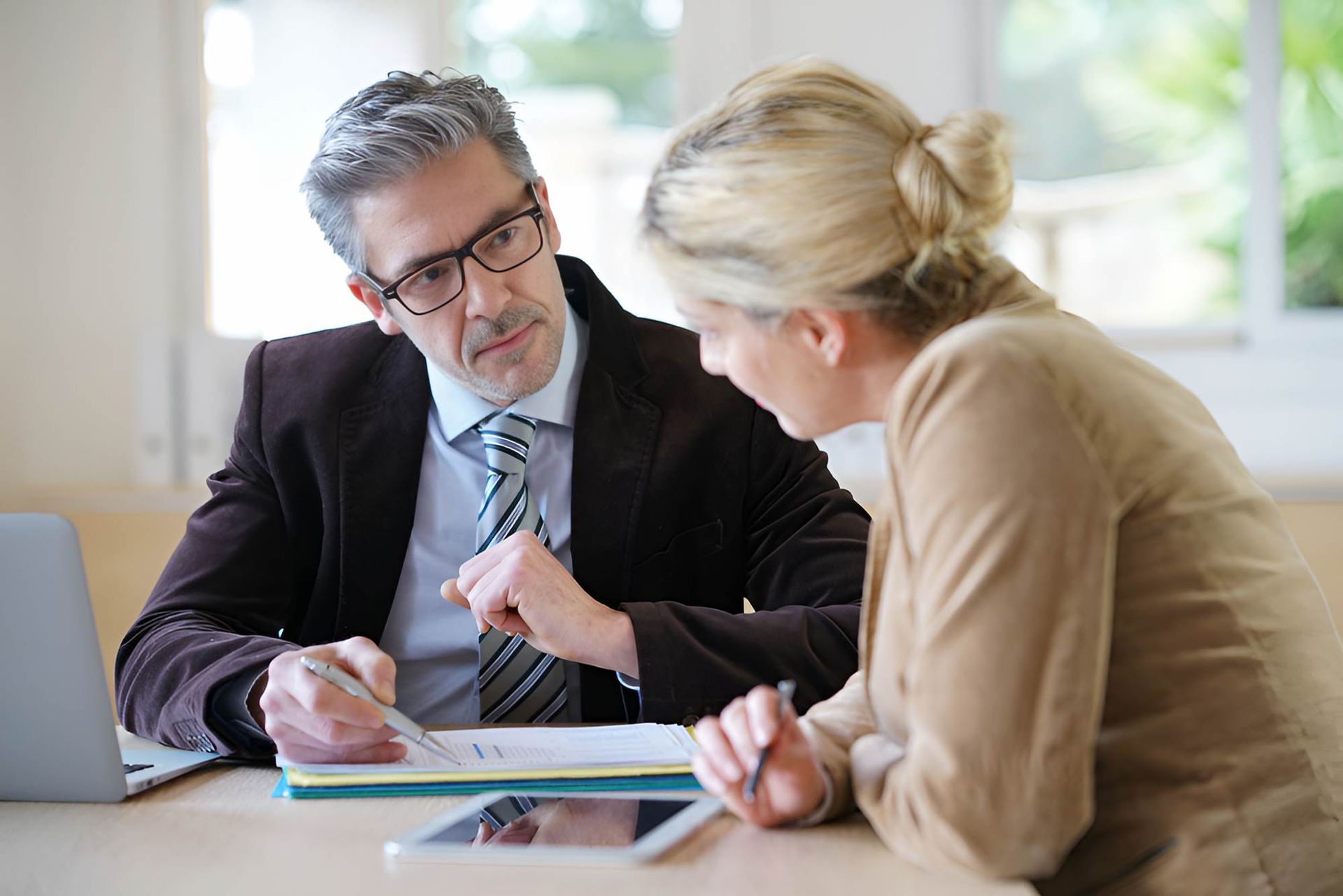 A Man and a Woman Are Sitting at a Table — O'Reilly & Sochacki Lawyers in Murwillumbah, NSW