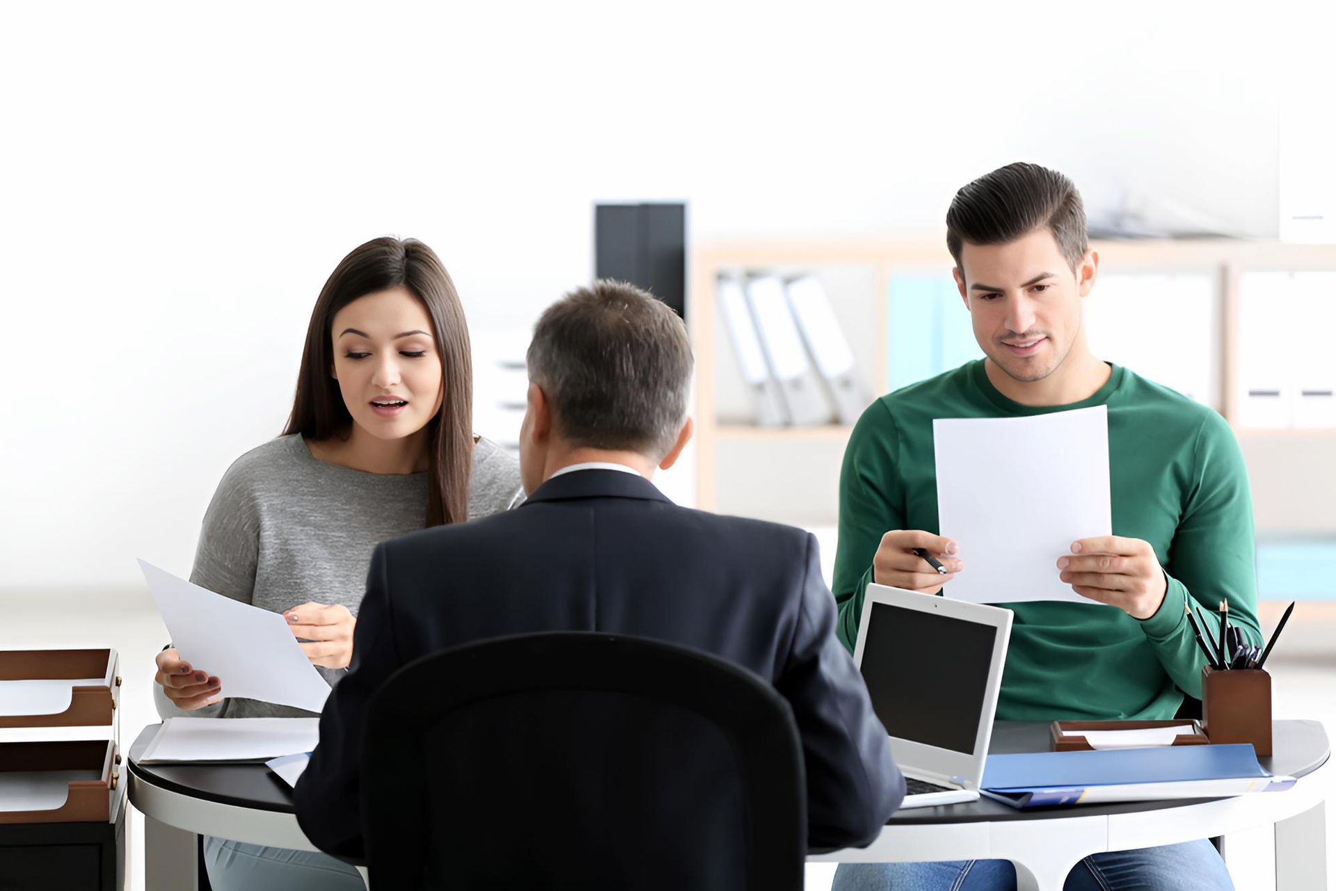 A Man is Talking at a Table With a Couple Client — O'Reilly & Sochacki Lawyers in Murwillumbah, NSW