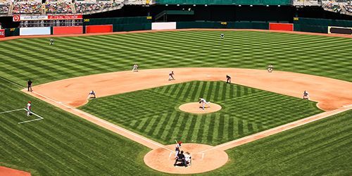 an aerial view of a baseball field with people playing baseball .