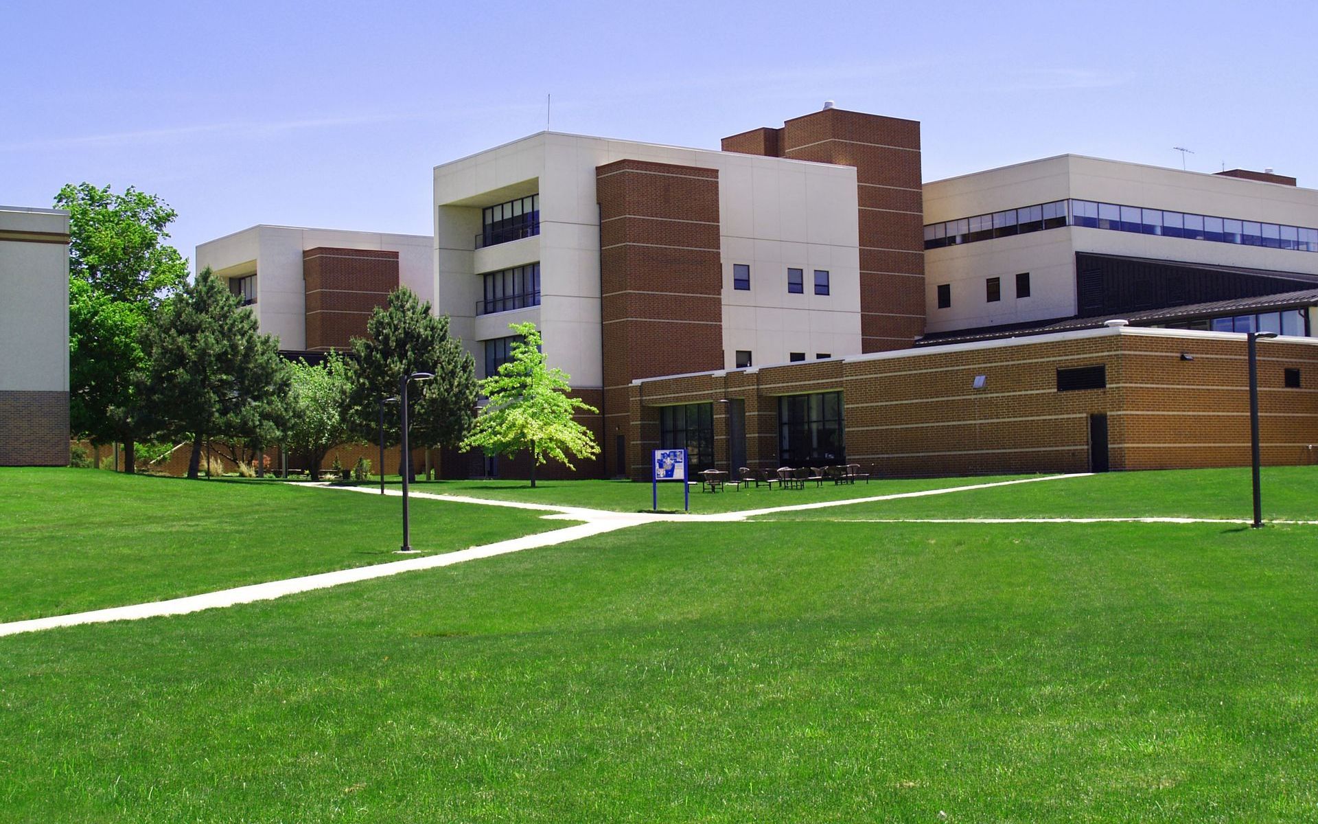 a large building with a lawn in front of it