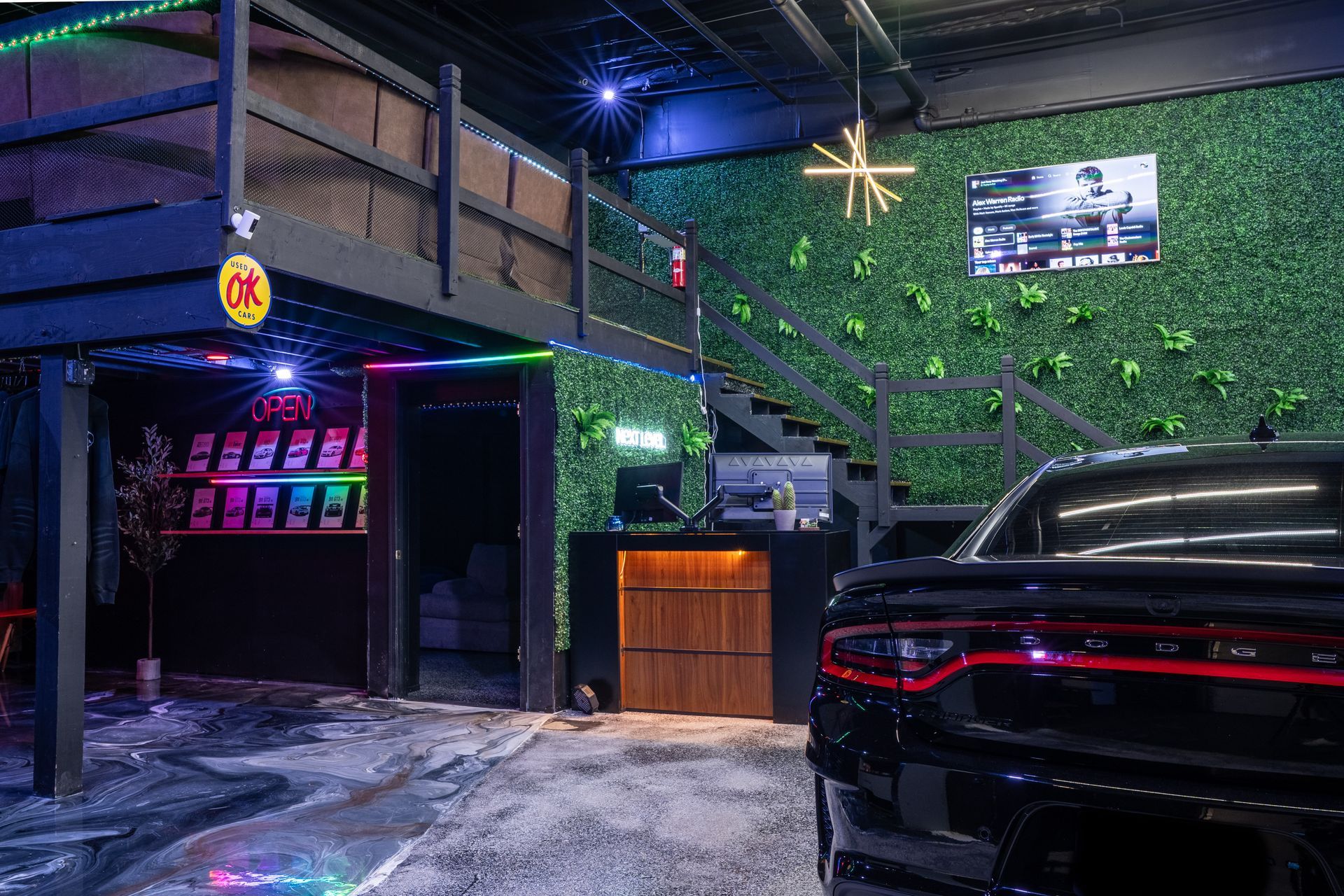 Silver Lamborghini Urus SUV with black hood, parked in front of a building on a sunny day.