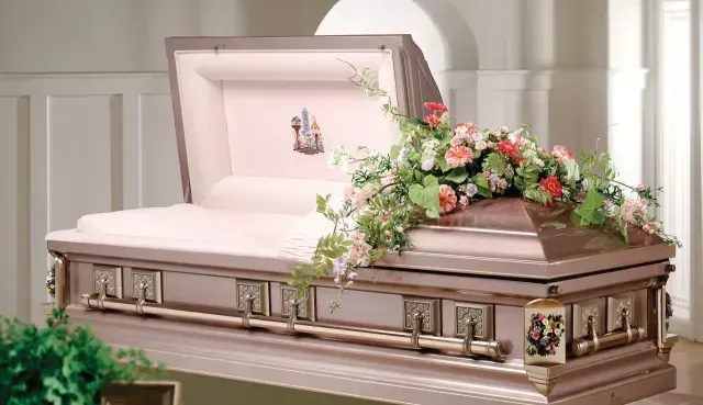 Open casket with white lining and pink-and-white flowers in a chapel