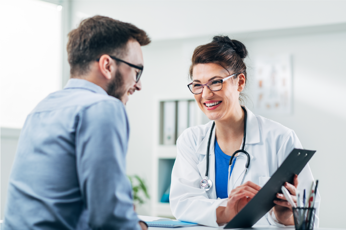 A woman is sitting at a table talking to another woman.