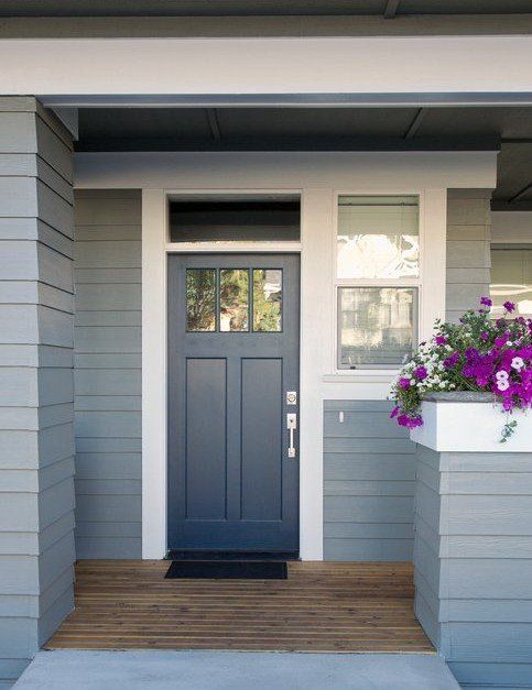 Navy blue wooden door on front entry of house