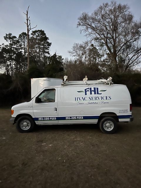 White FHL HVAC services van with logo parked outdoors.