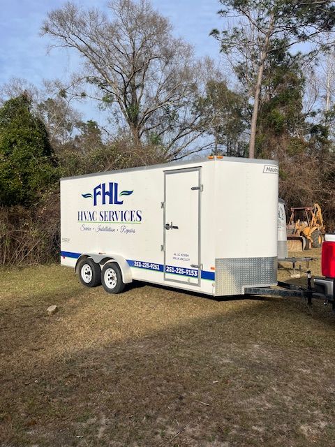 White trailer for FHL HVAC Services parked on grass with trees in background.