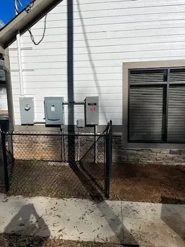 A white house with a chain link fence in front of it.