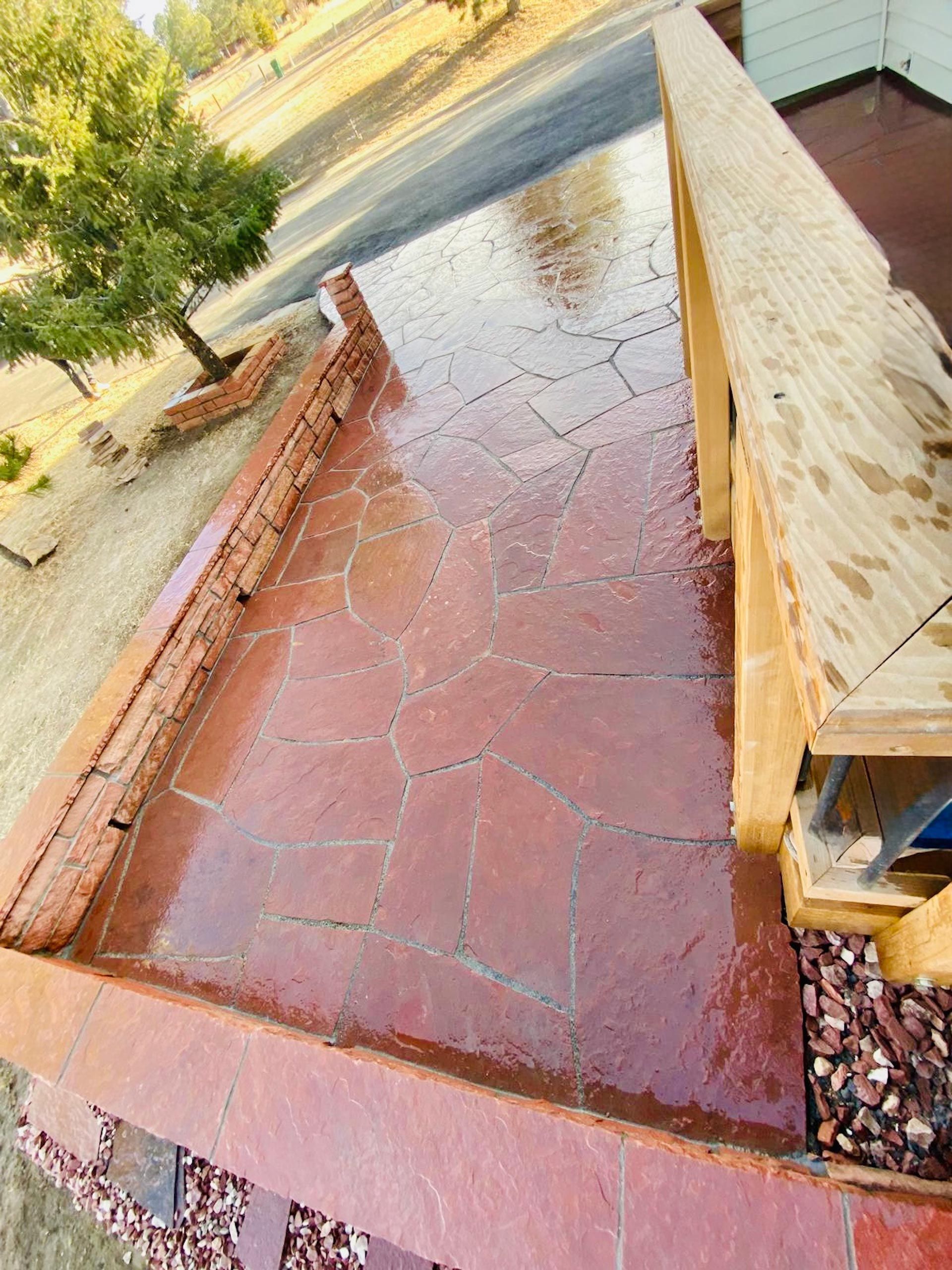 An aerial view of a brick walkway leading to a house.