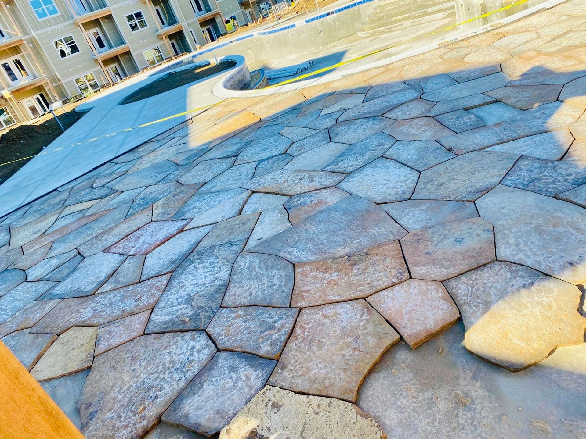 A brick walkway is being built in front of a building.