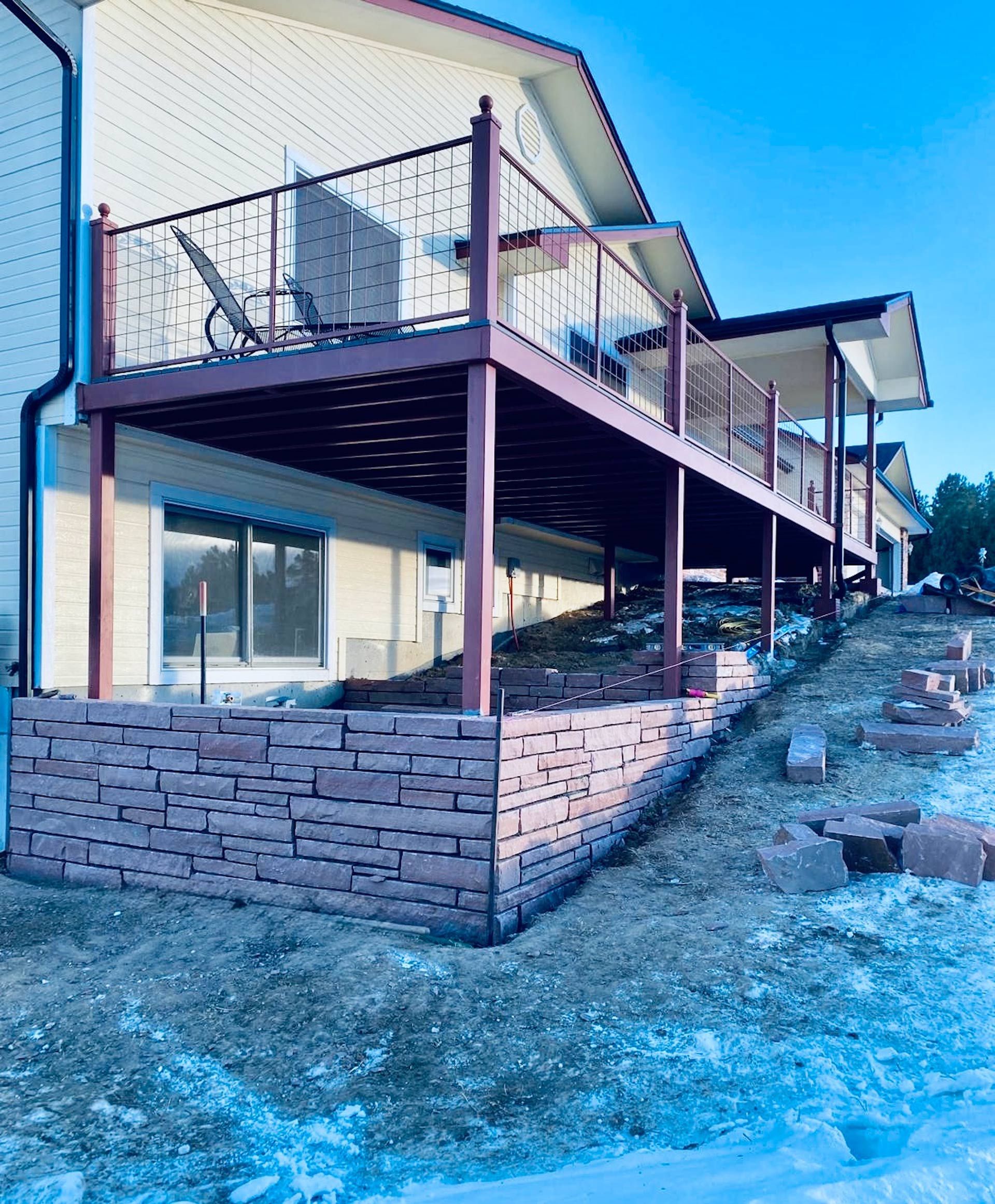 A house with a large deck on the side of it