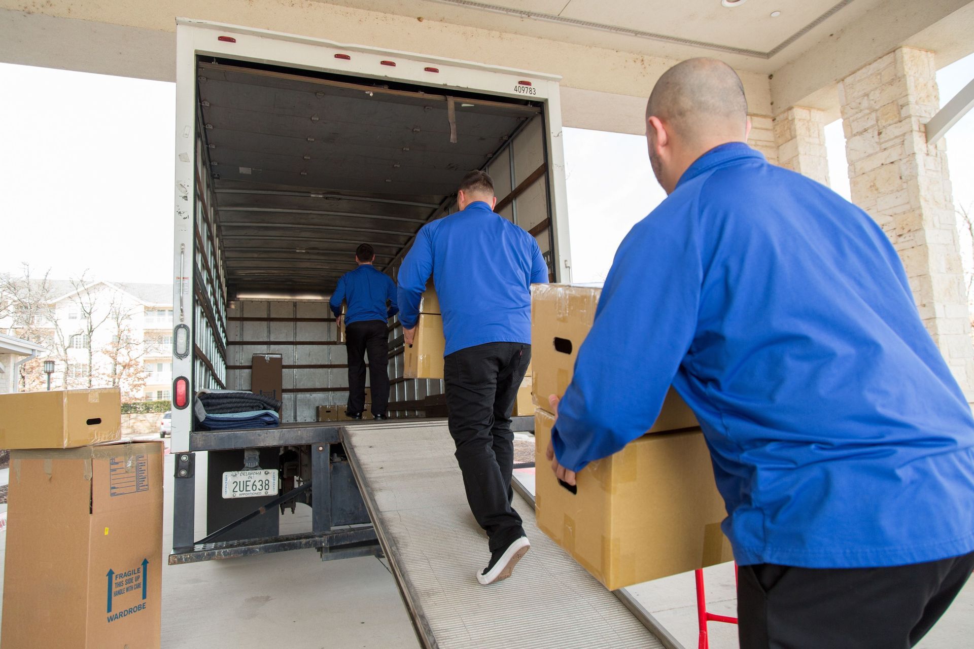 A group of men are loading boxes into a moving truck.