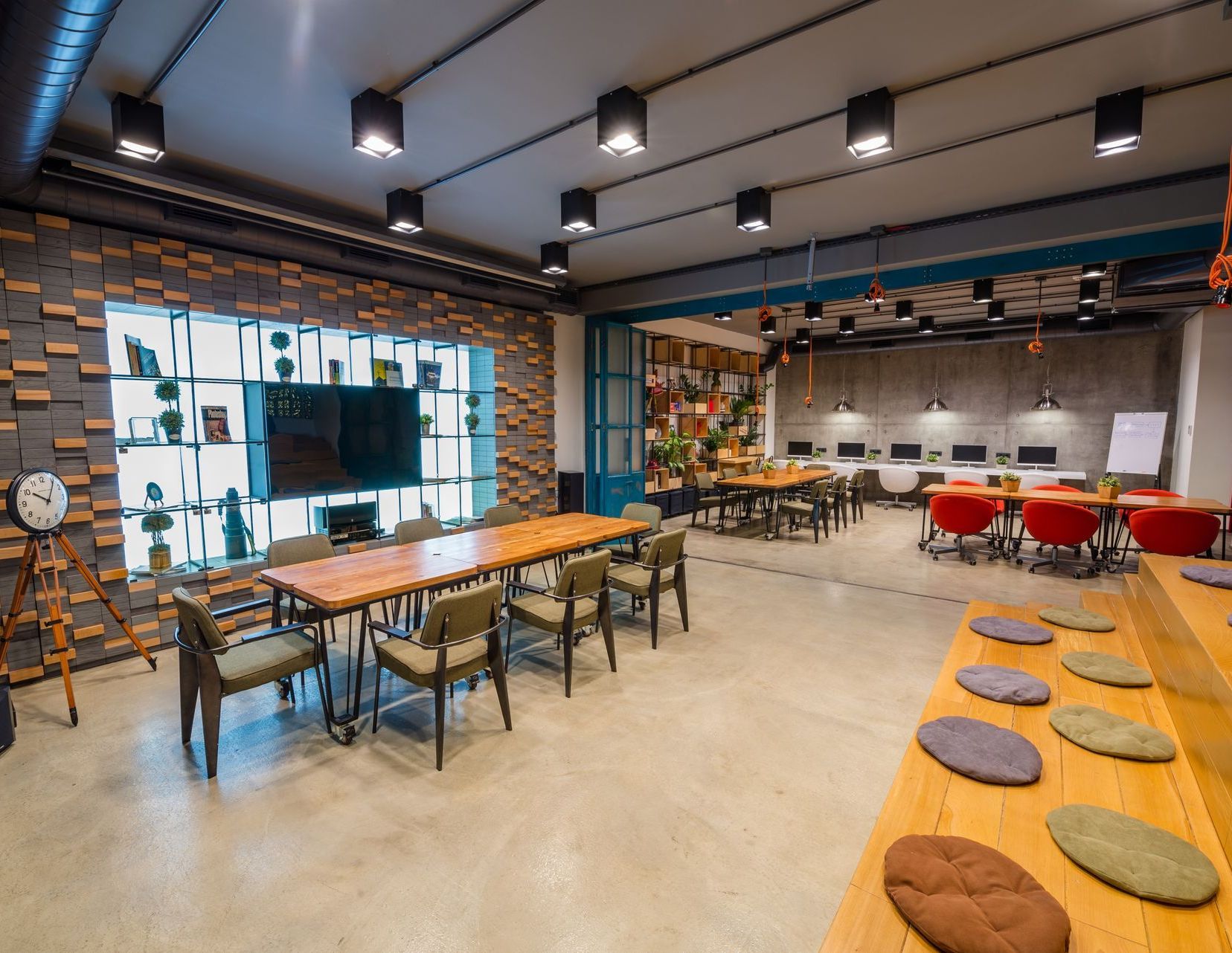 A large room with a long table and chairs in it.