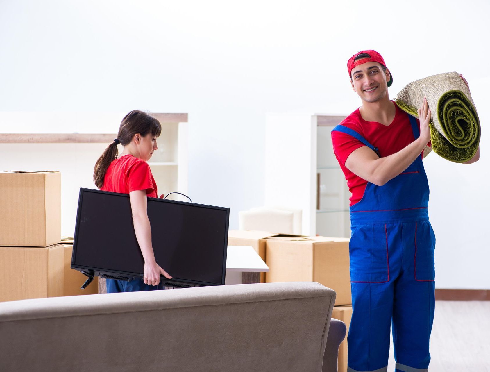 A man and a woman are packing things to move into a new house.