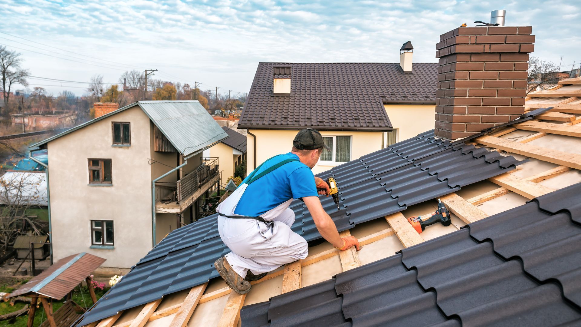 A man is working on the roof of a house.