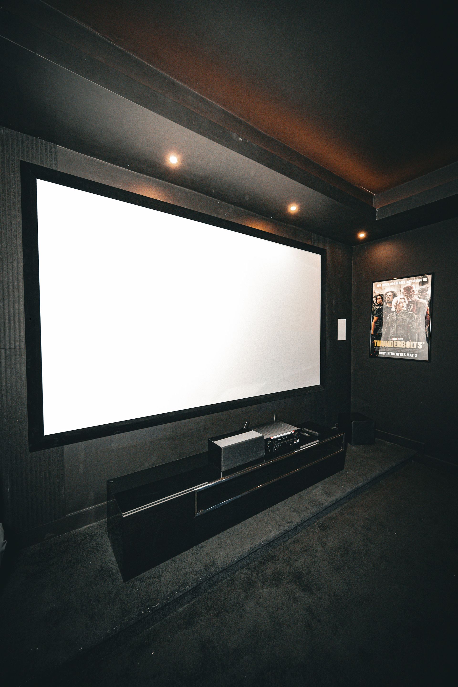 A home theater with a large screen and a projector.
