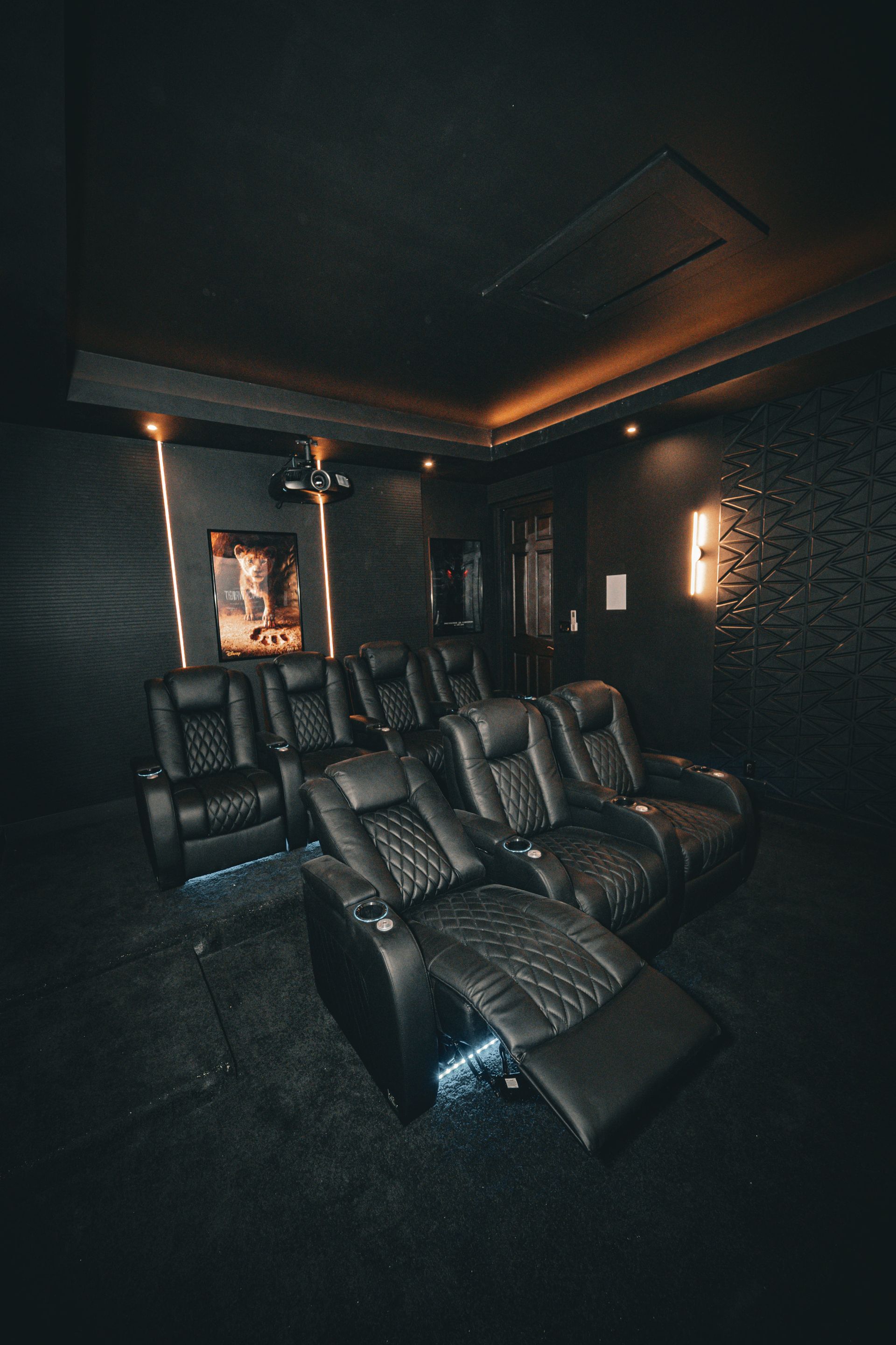 A home theater with a lot of chairs and a projector screen.